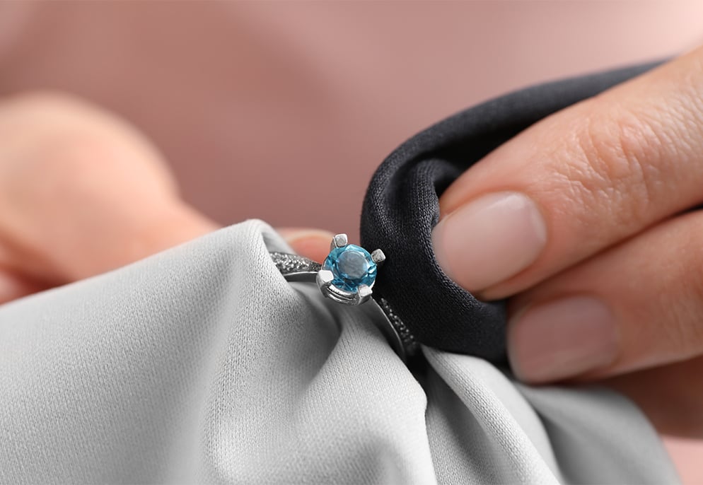 November Birthstone Guide for Retailers – Citrine & Topaz 6 Jeweler carefully cleaning and caring for a gemstone image