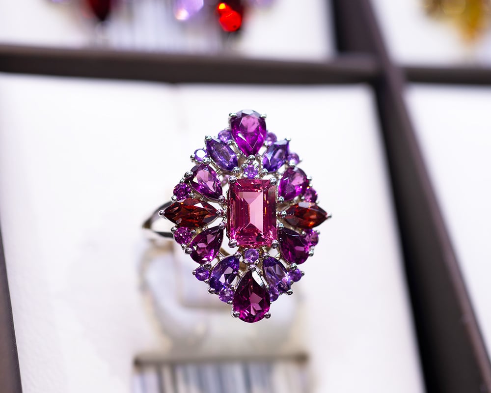 February Birthstone Guide for Retailers – Amethyst 6 Showcase displaying white gold ring with amethysts, rubies, and tourmalines image